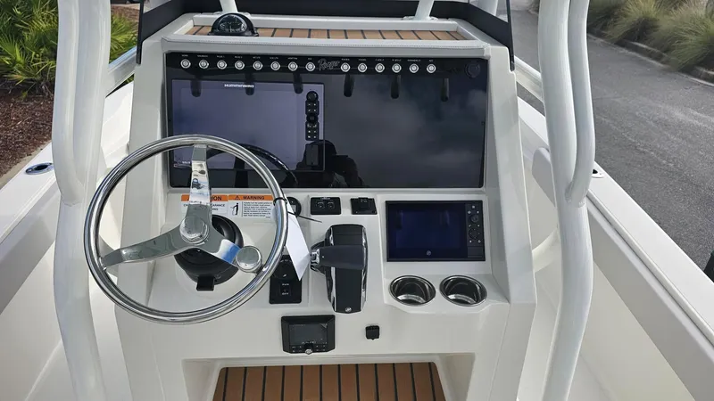 Slide: The Image of 2024 Ranger 2510 Bay boat console with steering wheel and navigation controls. - 8