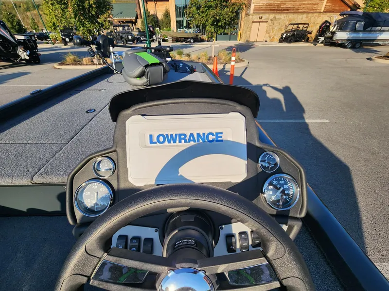 Slide: The Image of 2024 Ranger RT188 boat dashboard with Lowrance display in a parking lot. - 2