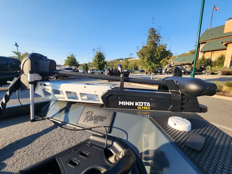 Slide: The Image of 2024 Ranger RT188 boat with Minn Kota Ultrex trolling motor in a sunny outdoor setting. - 3