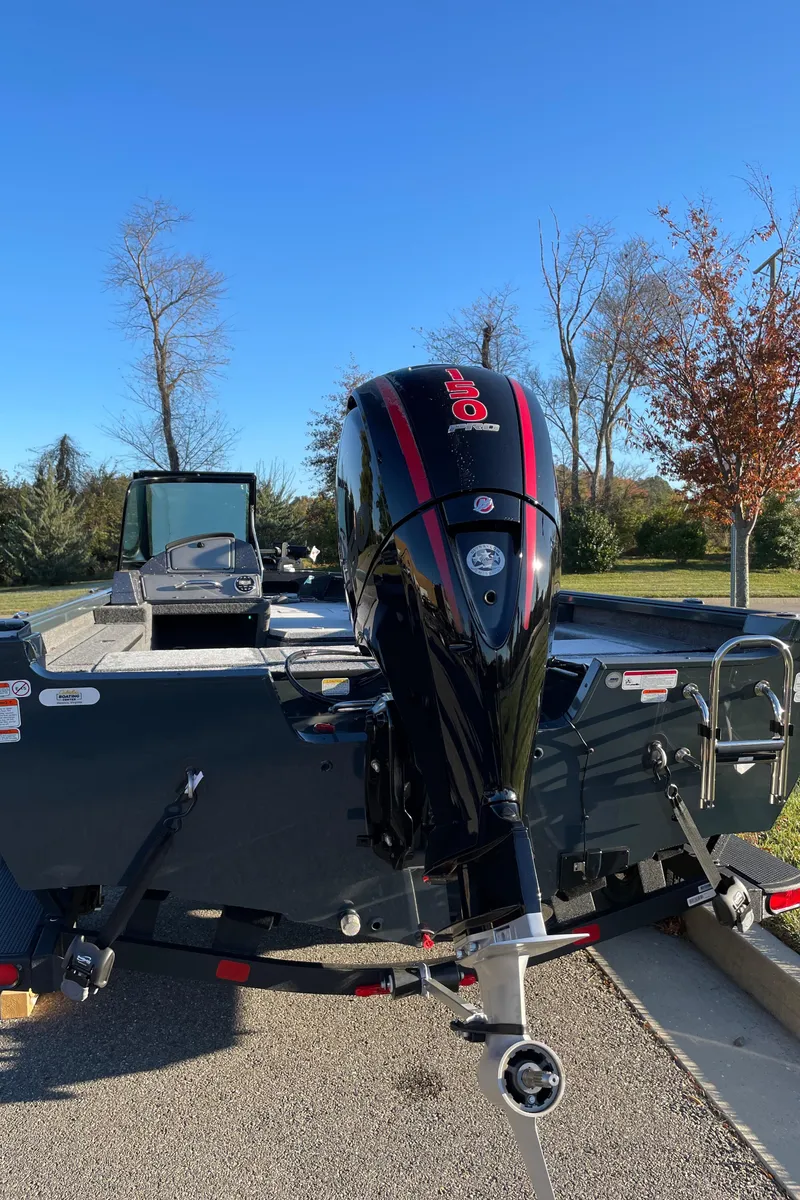 Slide: The Image of 2024 Ranger VS1782SC Reata boat with outboard motor in a parking lot. - 6