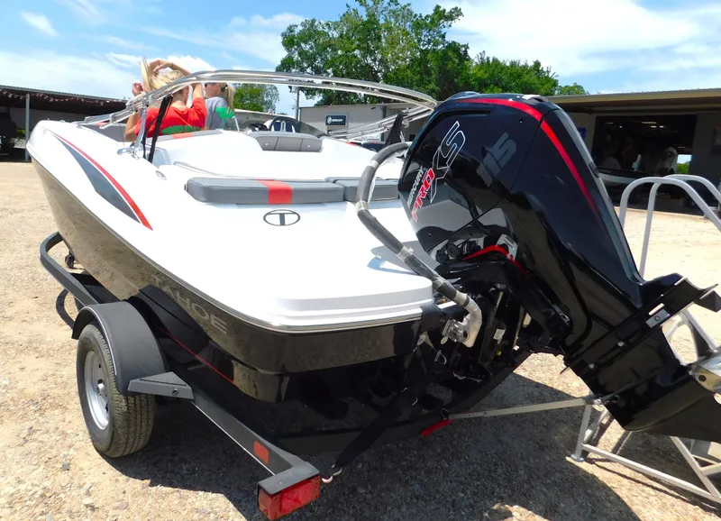 Slide: The Image of 2024 Tahoe T18 boat on trailer with outboard motor in outdoor setting. - 17