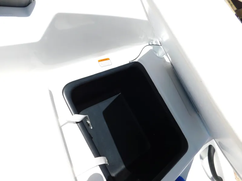 Slide: The Image of 2024 Tahoe T18 boat storage compartment with white and black interior. - 20
