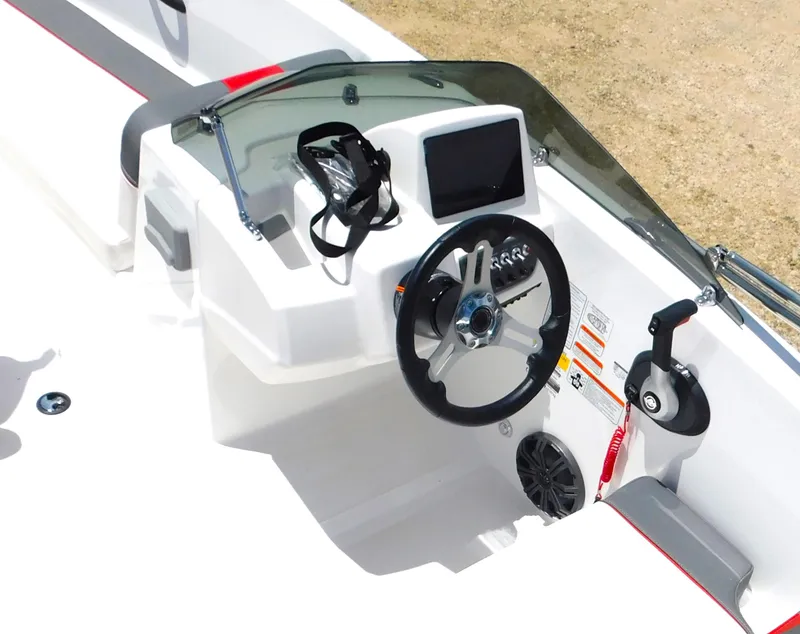 Slide: The Image of 2024 Tahoe T18 boat dashboard with steering wheel, control panel, and navigation screen. - 23