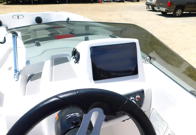 Slide: The Image of 2024 Tahoe T18 boat dashboard with steering wheel and touchscreen display. - 24