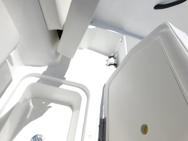 Slide: The Image of 2024 Tahoe T18 boat interior, white seating and storage compartments. - 27