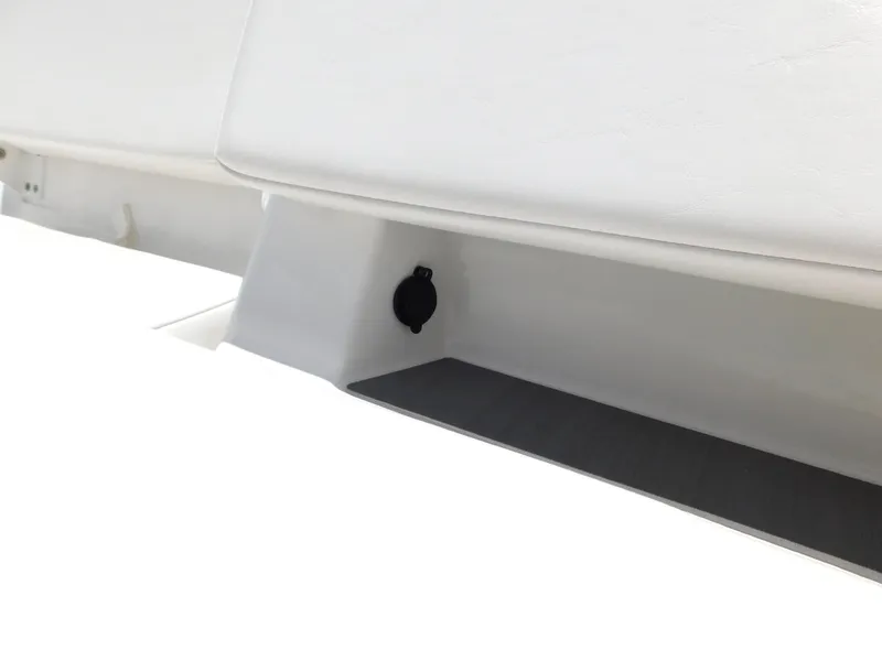 Slide: The Image of 2024 Tahoe T18 boat interior detail with white seating and black plug socket. - 28