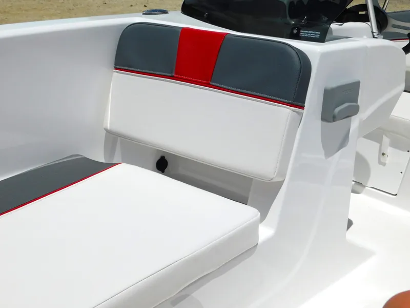 Slide: The Image of 2024 Tahoe T18 boat seating with white, gray, and red upholstery. - 29