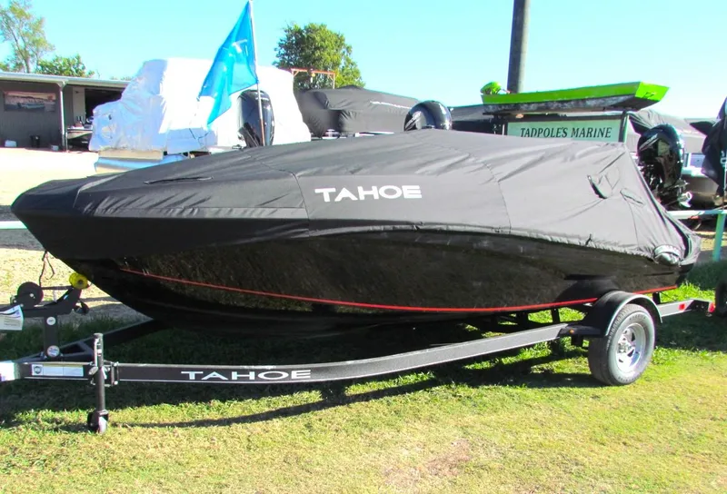 Slide: The Image of 2024 Tahoe T18 boat with cover on trailer at outdoor display. - 42