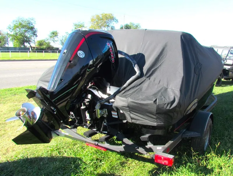 Slide: The Image of 2024 Tahoe T18 boat with cover and outboard motor on trailer. - 44