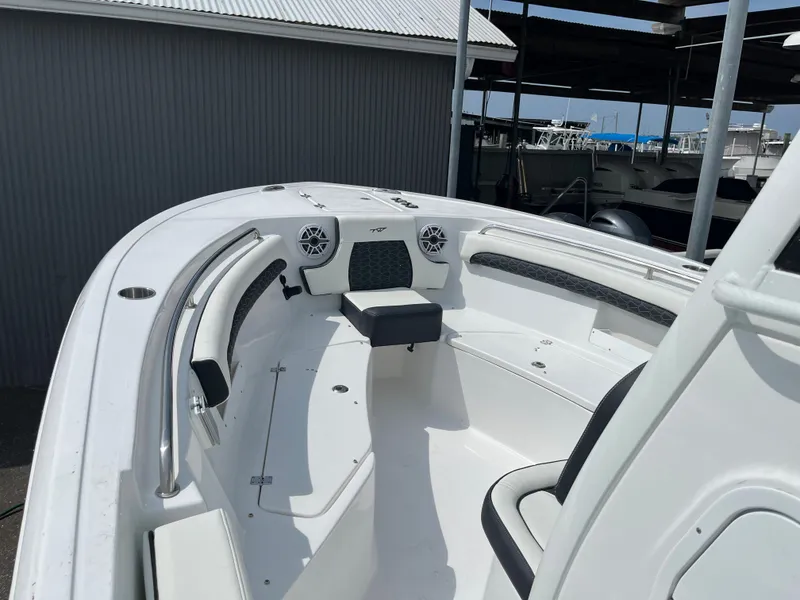 Slide: The Image of 2025 Tidewater 232 LXF boat interior with seating and speakers. - 6