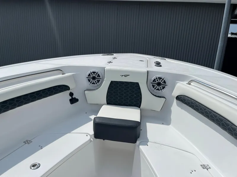 Slide: The Image of 2025 Tidewater 232 LXF boat interior with seating and speakers. - 7