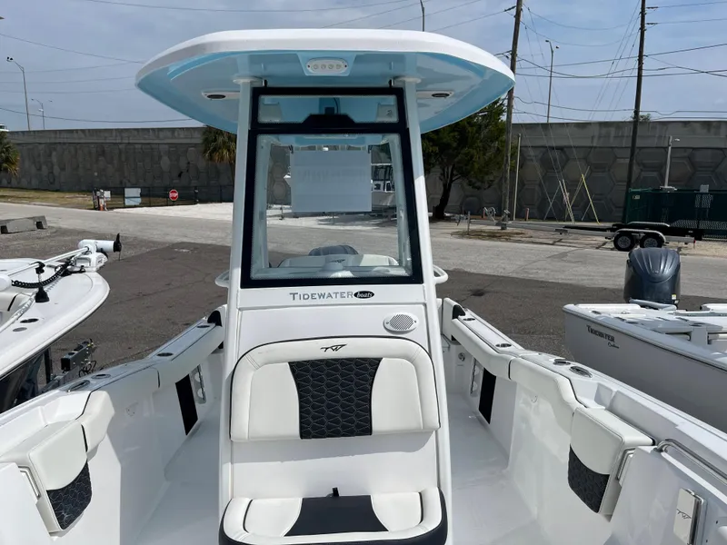 Slide: The Image of 2025 Tidewater 232 LXF boat, front view, docked in a marina. - 8