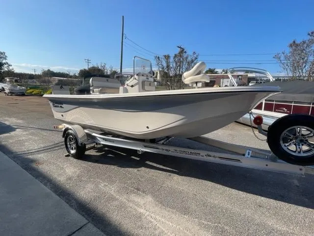 Slide: The Image of 2024 Carolina Skiff 19LS boat on a trailer in a parking lot. - 6
