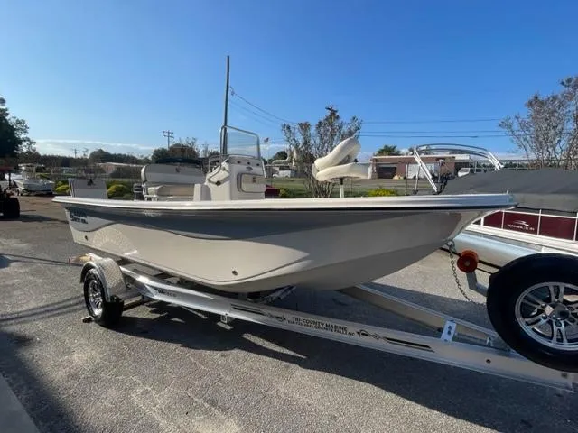 Slide: The Image of 2024 Carolina Skiff 19LS boat on a trailer in a parking lot. - 8