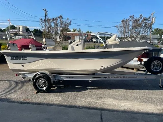 Slide: The Image of 2024 Carolina Skiff 19LS boat on a trailer in a parking lot. - 9
