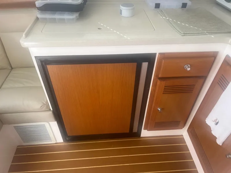 Slide: The Image of 2002 Cabo 35 Flybridge interior kitchen area with wood cabinetry. - 10
