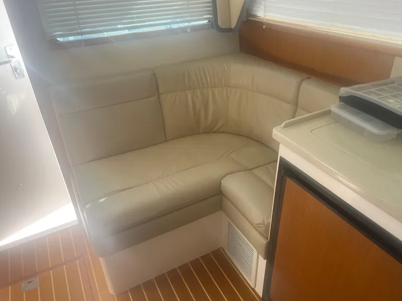 Slide: The Image of Interior of 2002 Cabo 35 Flybridge with beige leather sofa. - 11