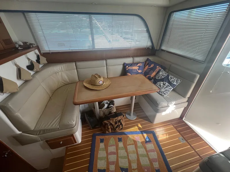Slide: The Image of 2002 Cabo 35 Flybridge interior with seating and table. - 12
