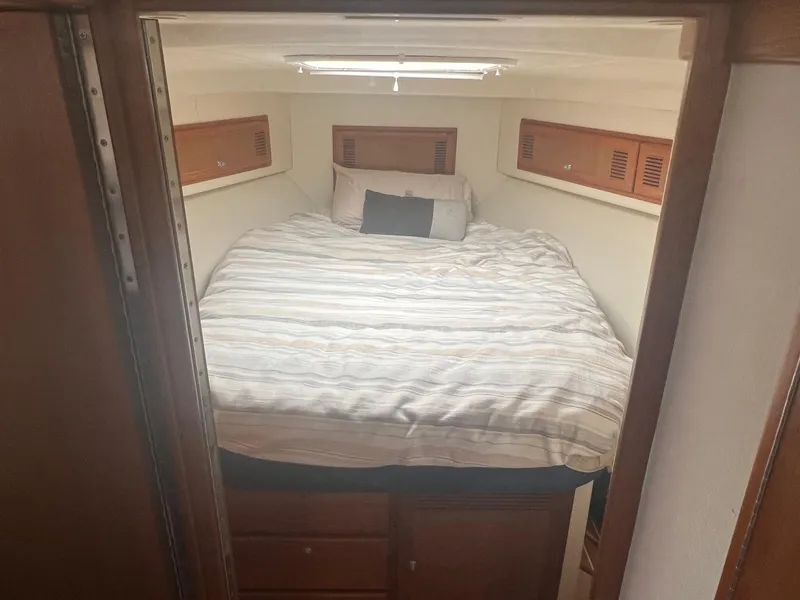 Slide: The Image of Interior of 2002 Cabo 35 Flybridge featuring a cozy bed. - 14