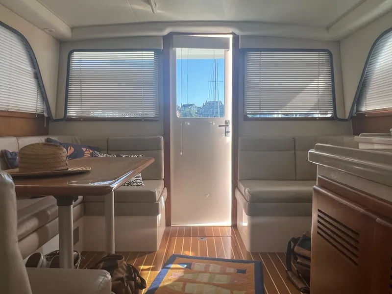 Slide: The Image of Interior of a 2002 Cabo 35 Flybridge yacht with wooden flooring. - 16