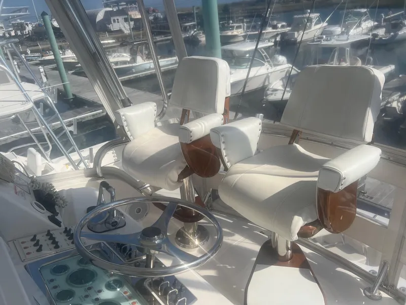 Slide: The Image of 2002 Cabo 35 Flybridge helm with dual captain chairs. - 4