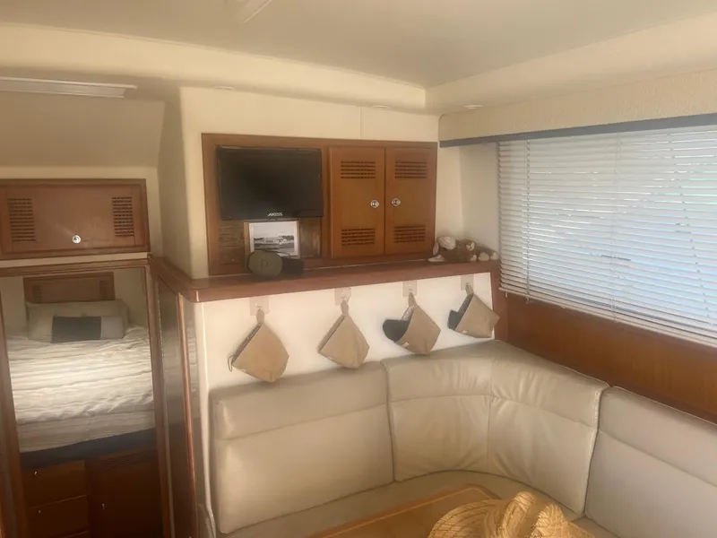 Slide: The Image of Interior of 2002 Cabo 35 Flybridge yacht with seating and TV. - 8
