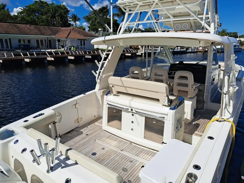 Slide: The Image of 2016 Boston Whaler 420 Outrage boat docked by waterfront homes. - 14