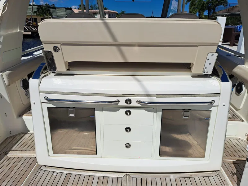 Slide: The Image of 2016 Boston Whaler 420 Outrage boat interior with storage compartments and seating. - 17