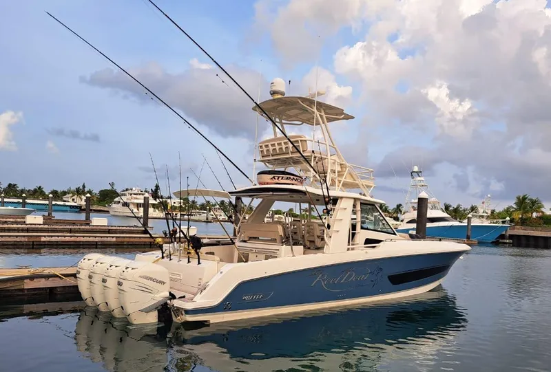 Slide: The Image of 2016 Boston Whaler 420 Outrage boat docked at marina with fishing rods. - 2