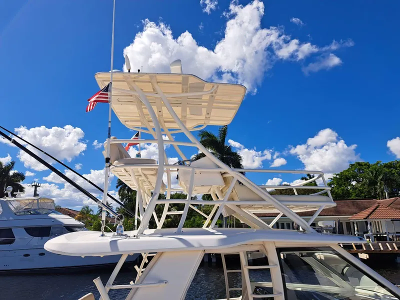 Slide: The Image of 2016 Boston Whaler 420 Outrage boat docked under a clear blue sky. - 21