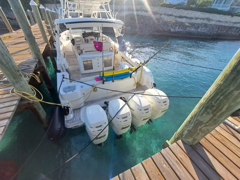 Slide: The Image of 2016 Boston Whaler 420 Outrage docked, featuring four powerful outboard engines. - 23