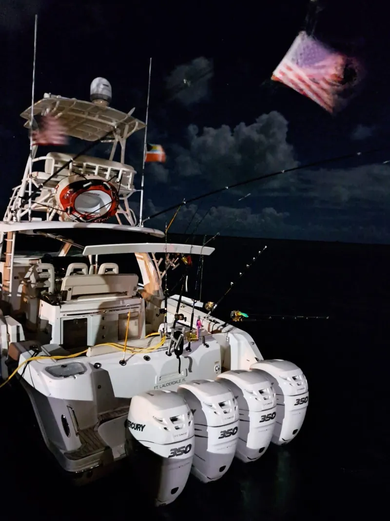 Slide: The Image of 2016 Boston Whaler 420 Outrage boat with four Mercury 350 engines at night. - 25