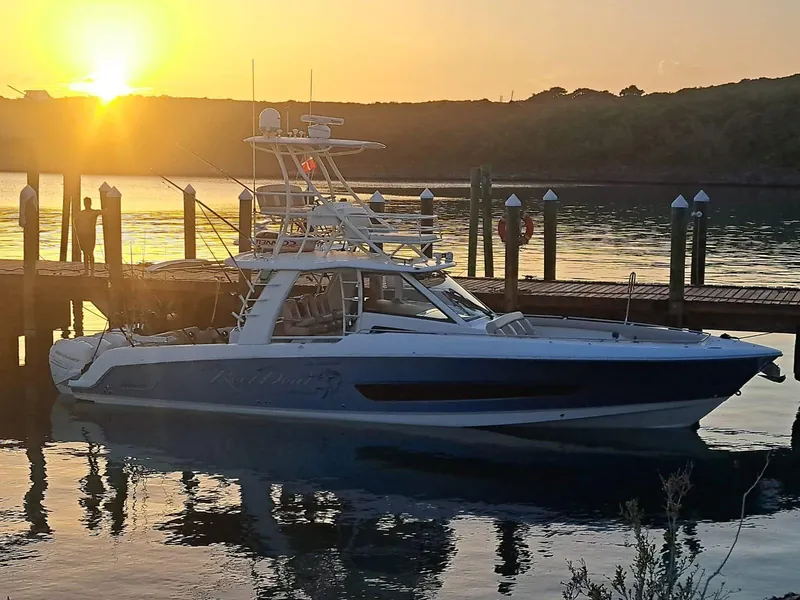Slide: The Image of 2016 Boston Whaler 420 Outrage docked at sunset. - 3