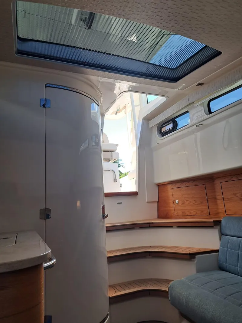 Slide: The Image of Interior cabin of a 2016 Boston Whaler 420 Outrage with modern design and skylight. - 32
