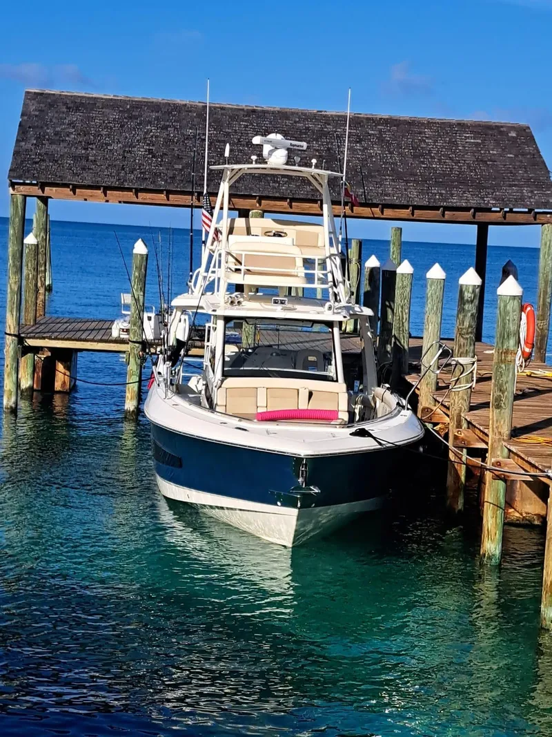 Slide: The Image of 2016 Boston Whaler 420 Outrage docked at a marina. - 5