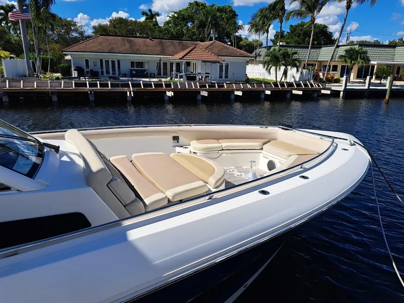 Slide: The Image of 2016 Boston Whaler 420 Outrage boat docked near waterfront homes. - 8