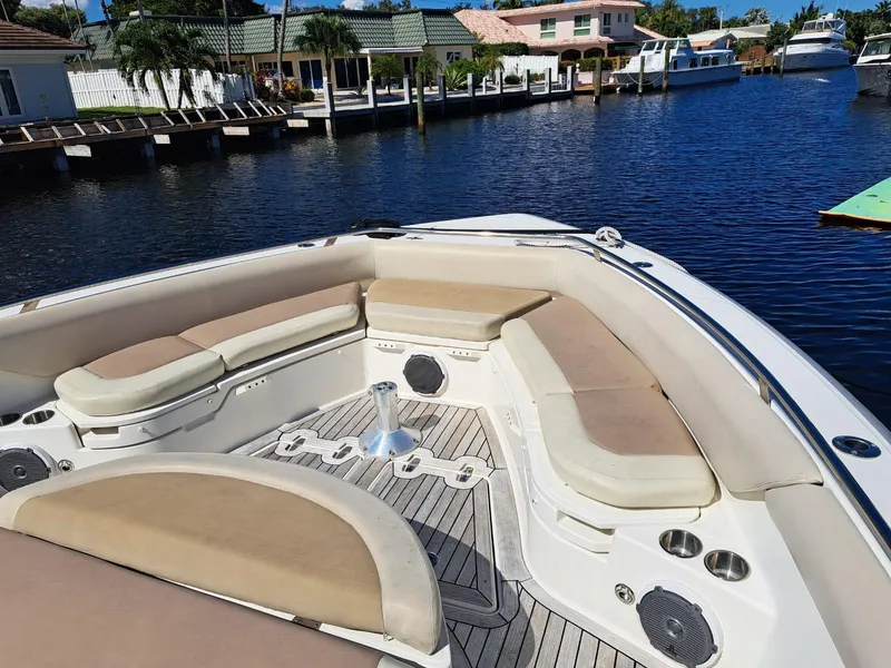 Slide: The Image of 2016 Boston Whaler 420 Outrage boat with spacious seating docked in a marina. - 9
