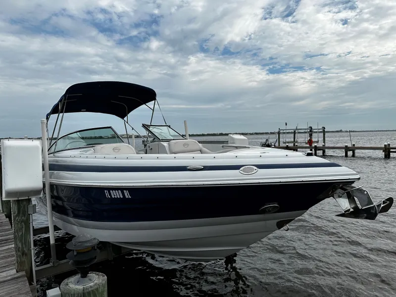 Slide: The Image of 2016 Crownline 285 SS boat docked by the water. - 0