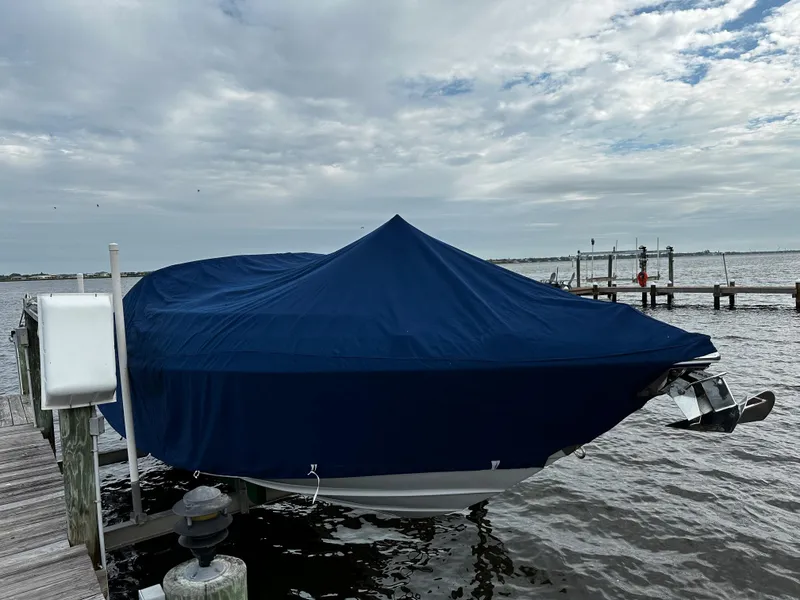 Slide: The Image of 2016 Crownline 285 SS boat covered with blue tarp at dock. - 11