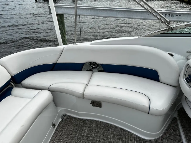 Slide: The Image of 2016 Crownline 285 SS boat interior with white and blue seating by the water. - 27