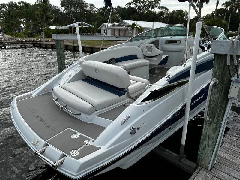 Slide: The Image of 2016 Crownline 285 SS boat docked, featuring spacious seating and sleek design. - 3