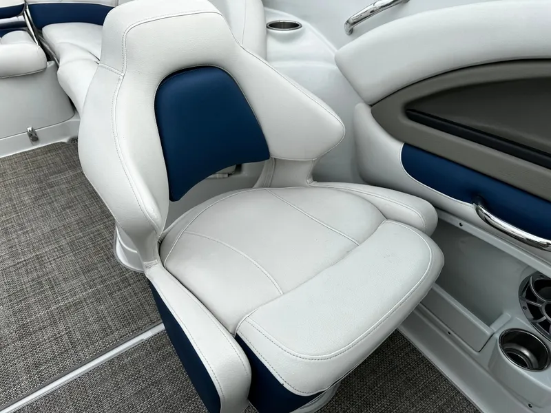 Slide: The Image of 2016 Crownline 285 SS boat interior with white and blue cushioned seat. - 33