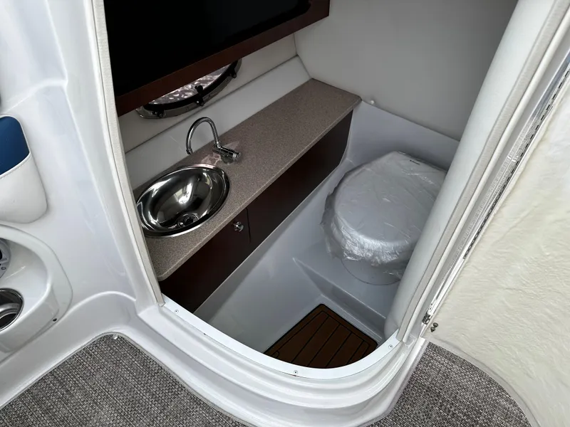 Slide: The Image of 2016 Crownline 285 SS boat interior bathroom with sink and toilet. - 36