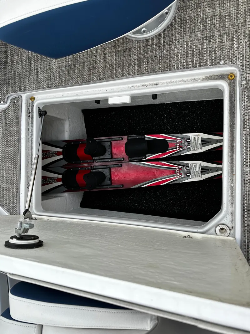 Slide: The Image of Storage compartment with water skis on a 2016 Crownline 285 SS boat. - 37