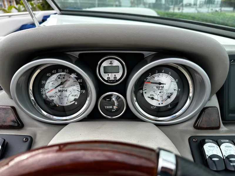 Slide: The Image of Dashboard of a 2016 Crownline 285 SS boat showing speedometer, tachometer, and trim gauge. - 41