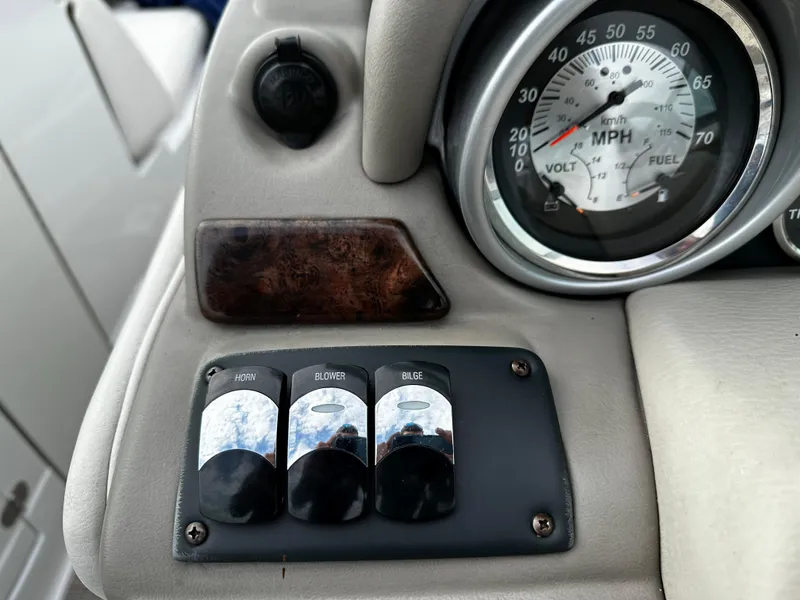 Slide: The Image of Control panel of a 2016 Crownline 285 SS boat with speedometer and switches. - 42