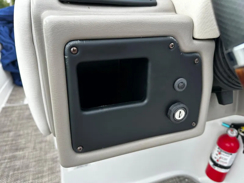 Slide: The Image of 2016 Crownline 285 SS boat dashboard compartment with lock and fire extinguisher. - 43