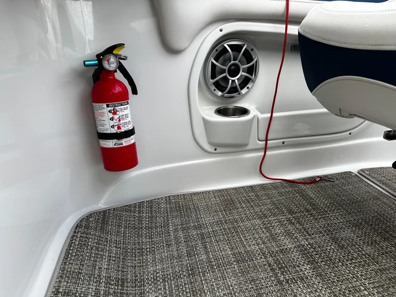 Slide: The Image of 2016 Crownline 285 SS interior with fire extinguisher, speaker, and cup holder. - 45