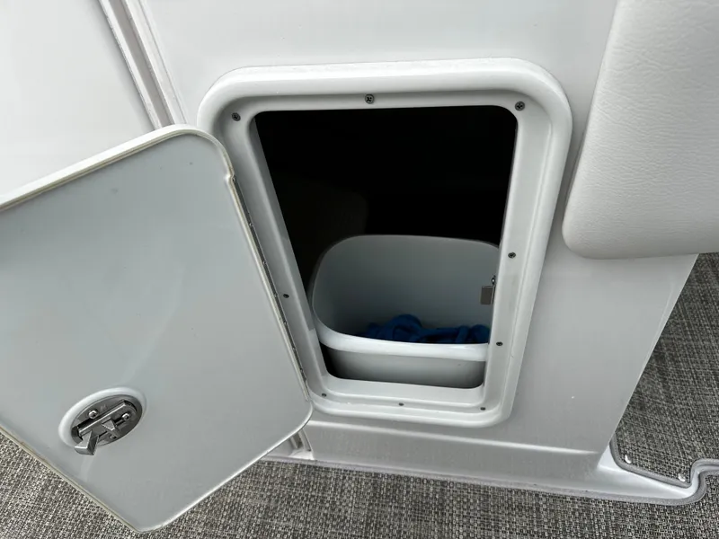 Slide: The Image of Open storage compartment on a 2016 Crownline 285 SS boat. - 49