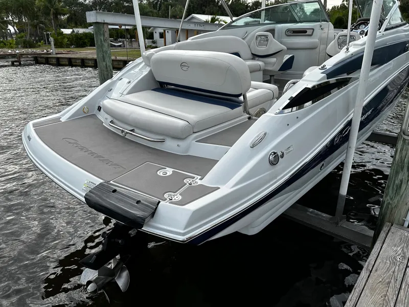 Slide: The Image of 2016 Crownline 285 SS boat docked, rear view showing seating and swim platform. - 5